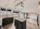Stylish kitchen with granite island, black cabinetry, and open floor plan at 378 Benton St, Castle Rock, CO 80104