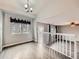 Open living space with natural light, white railing, and modern flooring at 378 Benton St, Castle Rock, CO 80104