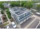 Aerial view showcasing a multi-story apartment building with garages, landscaping, and parking at 2809 Syracuse Ct # 129, Denver, CO 80238
