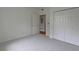 Bedroom featuring a closet, neutral carpet, light walls and a doorway to the hallway at 2809 Syracuse Ct # 129, Denver, CO 80238