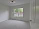 Bright, carpeted bedroom with a ceiling fan and natural light from a window at 2809 Syracuse Ct # 129, Denver, CO 80238
