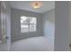Bright bedroom featuring a large window, neutral carpet, and a modern ceiling light fixture at 2809 Syracuse Ct # 129, Denver, CO 80238