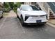 Close-up view of a modern white car parked outside a home at 2809 Syracuse Ct # 129, Denver, CO 80238