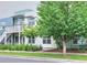 A contemporary two-story exterior featuring wood-grain siding and well-maintained landscaping and healthy trees at 2809 Syracuse Ct # 129, Denver, CO 80238