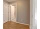 Hallway featuring a closet and bathroom, plus wood floors, and gray walls at 2809 Syracuse Ct # 129, Denver, CO 80238