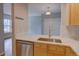 Modern kitchen featuring stainless steel appliances, a stylish backsplash, and abundant natural light at 2809 Syracuse Ct # 129, Denver, CO 80238