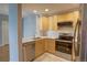 Contemporary kitchen featuring stainless appliances, sleek countertops, and ample cabinet space for storage at 2809 Syracuse Ct # 129, Denver, CO 80238