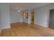 Cozy living space with light gray walls and hardwood floors offering a view into the modern kitchen at 2809 Syracuse Ct # 129, Denver, CO 80238