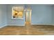 Spacious living room flows into a modern kitchen with stainless steel appliances and wood floors at 2809 Syracuse Ct # 129, Denver, CO 80238