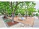 Outdoor common area with trees, picnic tables, and ample seating for residents at 2809 Syracuse Ct # 129, Denver, CO 80238