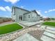 Spacious backyard featuring an extended patio, landscaped areas, and a play area at 11650 Lewiston Ct, Commerce City, CO 80022