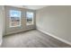 Empty bedroom featuring white trim and two large windows offering bright natural light at 11650 Lewiston Ct, Commerce City, CO 80022