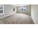 Spacious bedroom featuring natural light from three windows and carpeted floors at 11650 Lewiston Ct, Commerce City, CO 80022