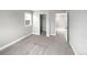 Clean bedroom with walk in closet and an adjacent door, illuminated by natural light at 11650 Lewiston Ct, Commerce City, CO 80022