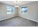 Bright dining room with large windows and a chandelier, perfect for Gathering gatherings at 11650 Lewiston Ct, Commerce City, CO 80022