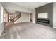 Open living space featuring a fireplace, hardwood floors, and staircase to the second floor at 11650 Lewiston Ct, Commerce City, CO 80022
