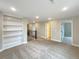 Bright and airy loft area featuring built in shelves and multiple entry doors at 11650 Lewiston Ct, Commerce City, CO 80022