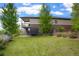 Expansive backyard with lush green lawn, patio, and playful trampoline at 26143 E Fremont Pl, Aurora, CO 80016