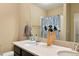 Bright bathroom featuring double sinks, quartz countertop and a large framed mirror at 26143 E Fremont Pl, Aurora, CO 80016
