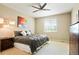 Bright bedroom with a ceiling fan, neutral walls, a queen bed, and a sunny window at 26143 E Fremont Pl, Aurora, CO 80016