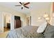 Comfortable bedroom with neutral tones, ceiling fan, and view into the en-suite bathroom at 26143 E Fremont Pl, Aurora, CO 80016