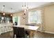 Dining area featuring stylish lighting, hardwood floors, and modern decor at 26143 E Fremont Pl, Aurora, CO 80016