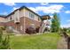 Charming exterior view of the home with a well-maintained lawn and deck at 26143 E Fremont Pl, Aurora, CO 80016