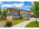 Beautiful home featuring a well-manicured lawn, covered porch, and a three car garage at 26143 E Fremont Pl, Aurora, CO 80016