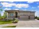 Charming home with a covered front porch, three car garage, and beautiful landscaping at 26143 E Fremont Pl, Aurora, CO 80016