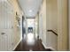 Bright hallway features a barn door, wood floors, and staircase at 26143 E Fremont Pl, Aurora, CO 80016