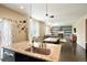 Open kitchen with granite countertops, stainless steel dishwasher, and views into the dining and living areas at 26143 E Fremont Pl, Aurora, CO 80016