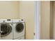 Convenient laundry room equipped with a modern, front-load washer and dryer at 26143 E Fremont Pl, Aurora, CO 80016