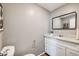 Well-lit powder room features a granite countertop, modern mirror, and fixtures at 1349 Race St # 5, Denver, CO 80206