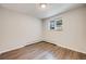Bright bedroom with hardwood floors and a window with an air conditioning unit at 1349 Race St # 5, Denver, CO 80206