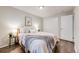 Comfortable bedroom featuring hardwood floors, a queen-sized bed, and an adjacent closet at 1349 Race St # 5, Denver, CO 80206