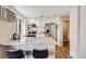 Well-lit kitchen featuring white cabinets, stainless steel appliances, and a breakfast bar at 1349 Race St # 5, Denver, CO 80206