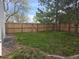 This backyard has a tall wooden privacy fence and grass at 2358 Dogwood Cir, Louisville, CO 80027