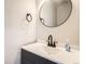 A close-up of a sink and vanity in a well-lit modern half-bathroom featuring updated hardware at 2358 Dogwood Cir, Louisville, CO 80027