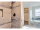 Elegant bathroom featuring modern tile in the shower, a soaking tub, and modern hardware at 2358 Dogwood Cir, Louisville, CO 80027