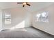 Bright bedroom with vaulted ceilings, and carpet, illuminated by natural light from two windows at 2358 Dogwood Cir, Louisville, CO 80027