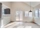 Sun-filled dining area featuring hardwood floors, sliding glass doors, and stylish lighting fixtures at 2358 Dogwood Cir, Louisville, CO 80027