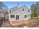This home has gray siding, a brick patio, a chimney, and beautiful curb appeal at 2358 Dogwood Cir, Louisville, CO 80027