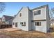 The backyard of this home has gray siding and a small brick patio at 2358 Dogwood Cir, Louisville, CO 80027