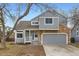 Inviting home with a stone-accented front, a covered porch, and an attached two-car garage at 2358 Dogwood Cir, Louisville, CO 80027