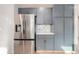 Well-equipped kitchen featuring stainless steel refrigerator and modern cabinets, offering ample storage at 2358 Dogwood Cir, Louisville, CO 80027
