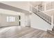 Bright living room featuring hardwood floors, modern staircase, and plenty of natural light at 2358 Dogwood Cir, Louisville, CO 80027