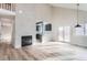 Open living room with a fireplace, wood floors, and an open layout that flows into the kitchen at 2358 Dogwood Cir, Louisville, CO 80027