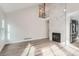 Bright living room featuring a modern fireplace with a unique textured wall and wood flooring at 2358 Dogwood Cir, Louisville, CO 80027