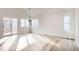 Sunlit living room featuring sliding glass doors and many windows offering plenty of natural light at 2358 Dogwood Cir, Louisville, CO 80027
