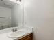 Half bathroom featuring a single vanity, large mirror, and tiled floors at 1514 S Ouray Cir # B, Aurora, CO 80017